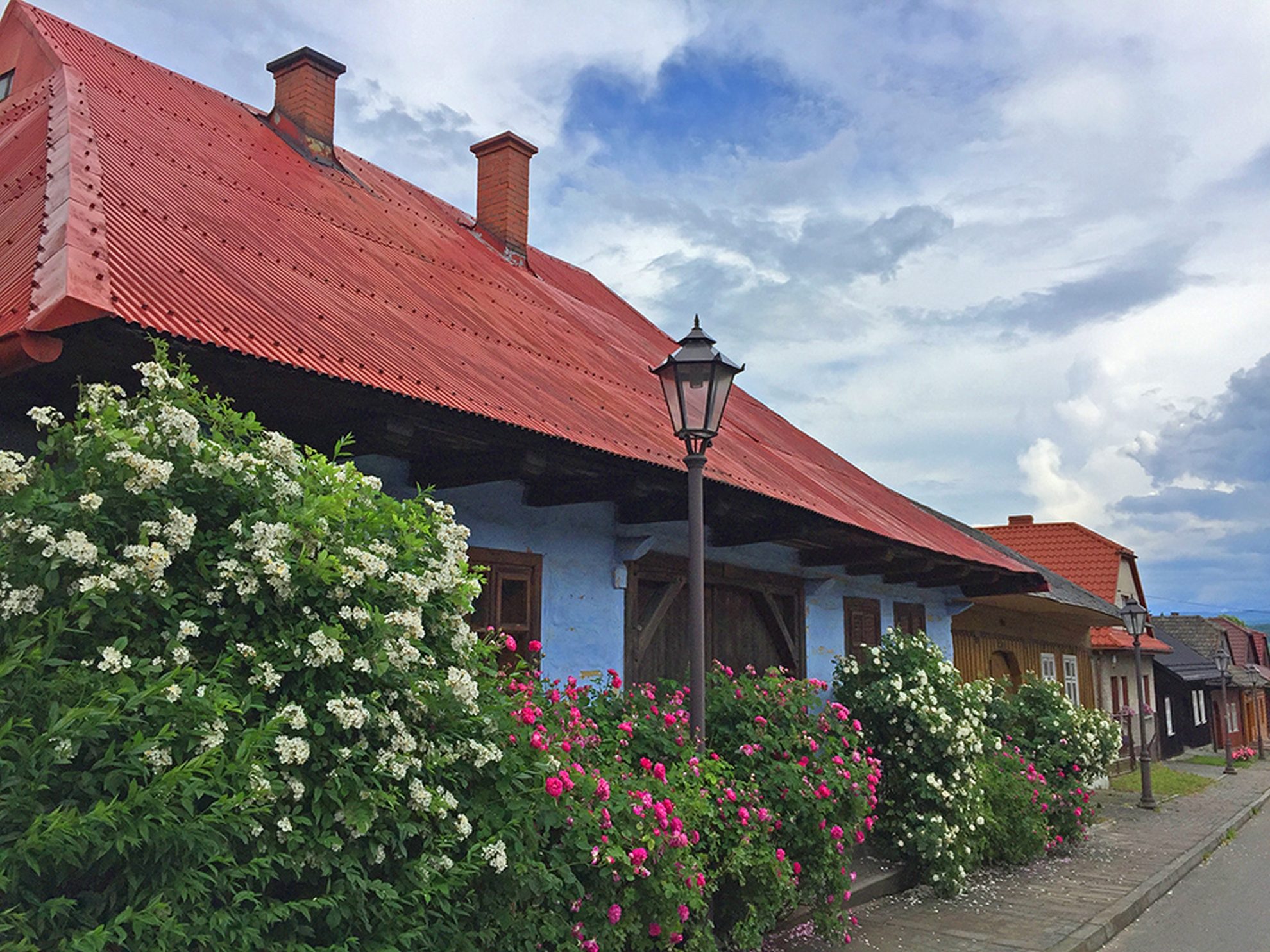 Wooden houses with roses in Lanckorona