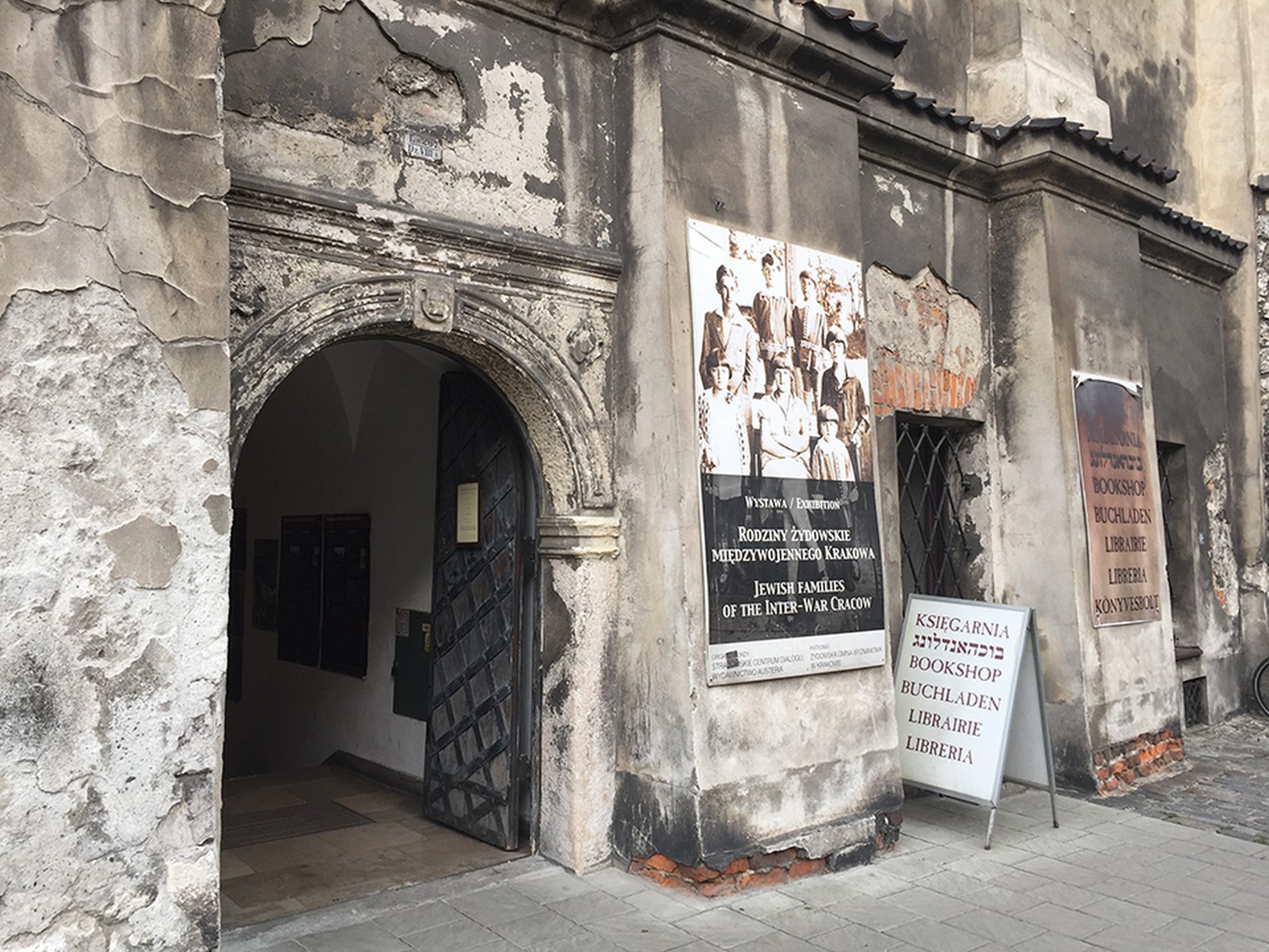 An old gateway in Kazimierz with notices about the Jewish community
